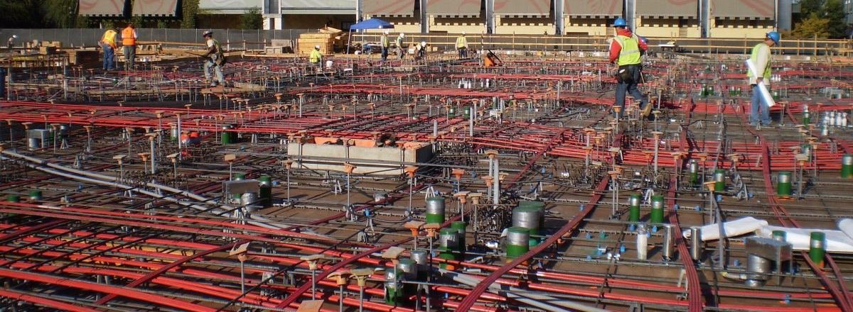 Post-tension cables and rebar laid across a concrete deck before a pour